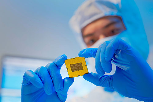 A man inspects a circuit board in a clinical setting